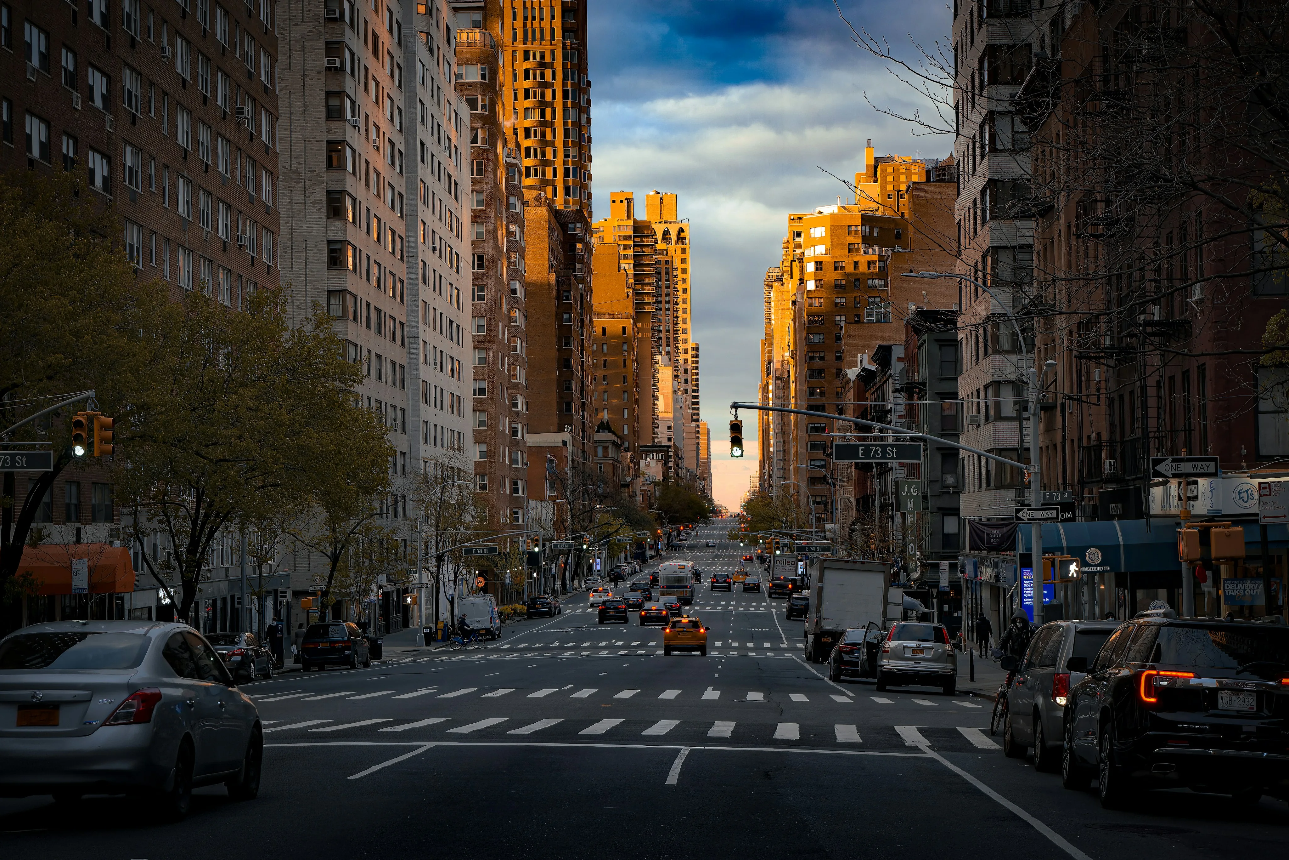 Upper East Side avenue lined with residential buildings at sunset